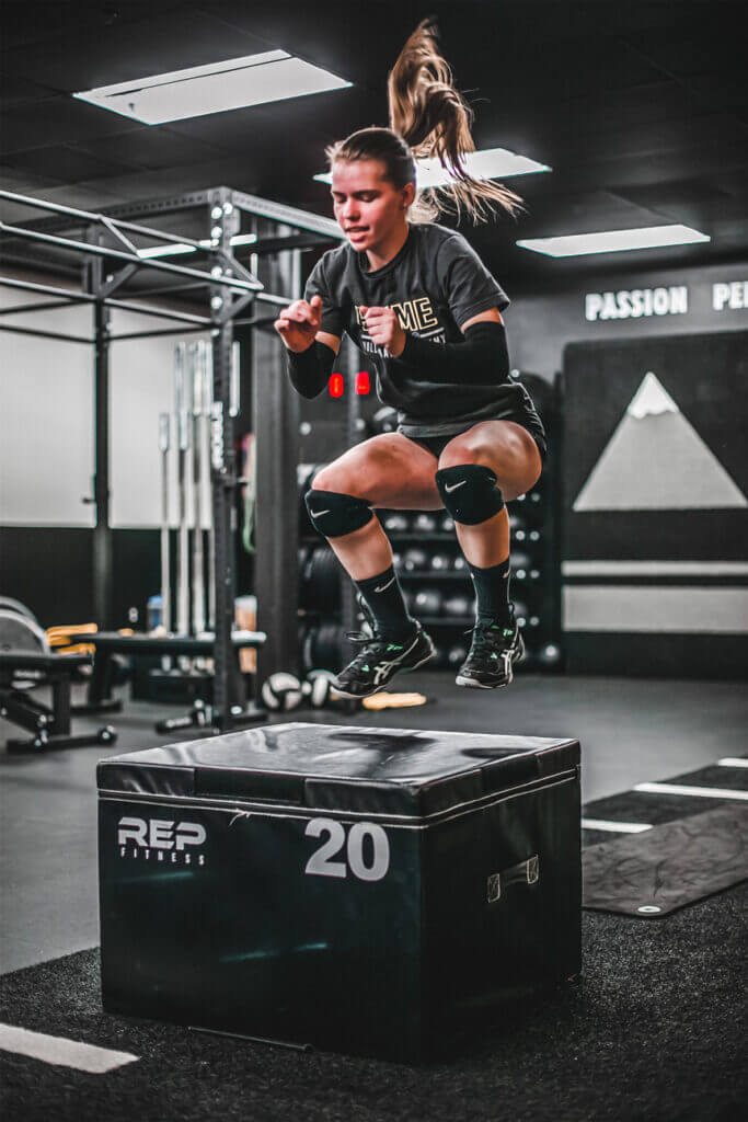 Girl jumping up onto box